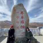Tourists at a stone monument in Tibet